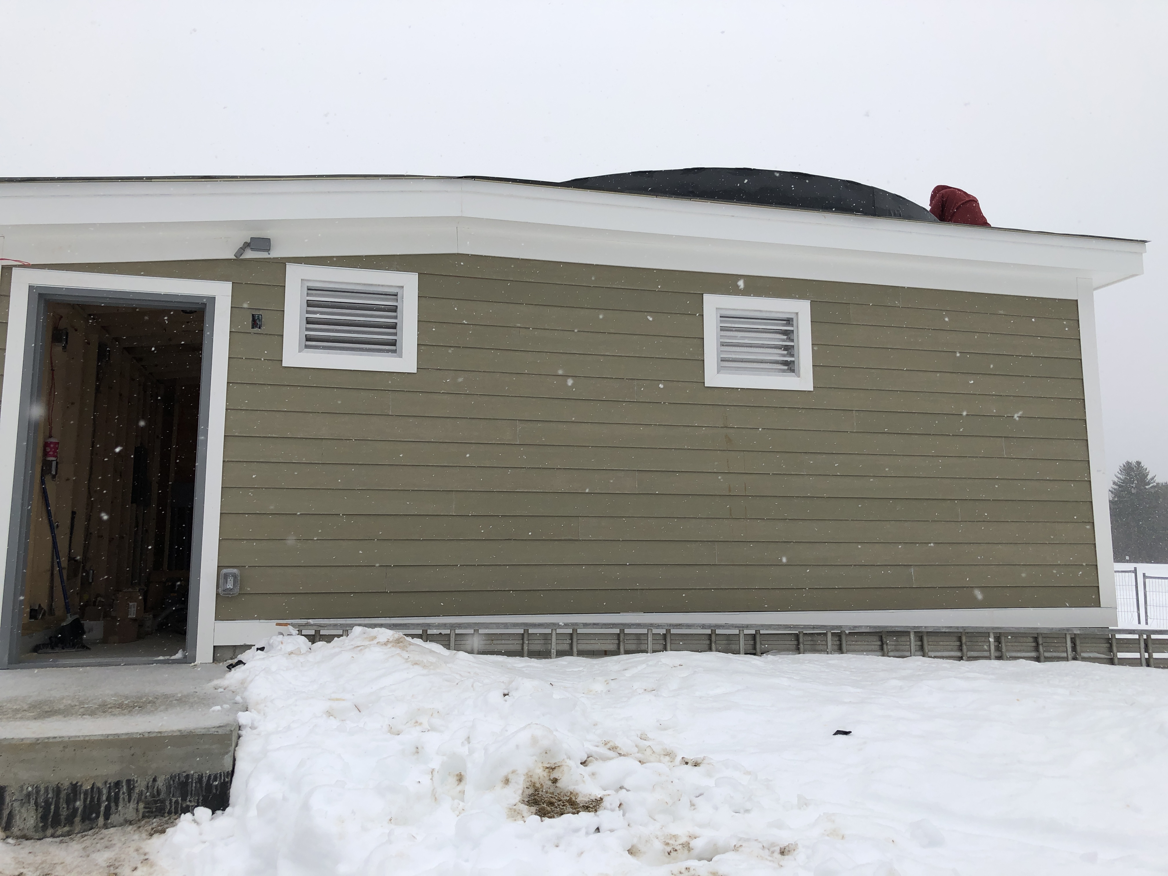 All four exterior walls now have been sided, ventilation louvers have been installed, and the roofers are working on the rubberized layer on top the structure and around the dome, base frame.